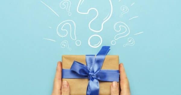 A paper-wrapped gift with a blue bow with a question mark above it.